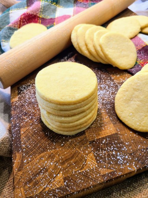 Stack of sugar cookies on cutting board