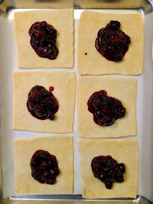 Blackberry turnovers with filling before closing