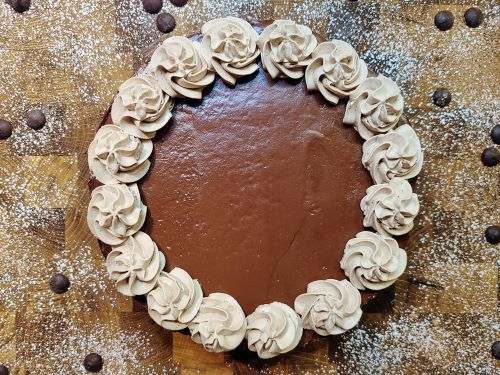 Chocolate cheesecake with whipped cream and ganache