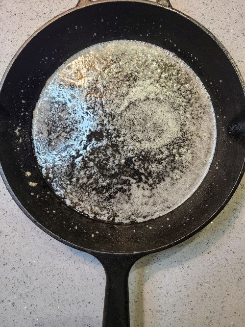 Butter melting in iron skillet