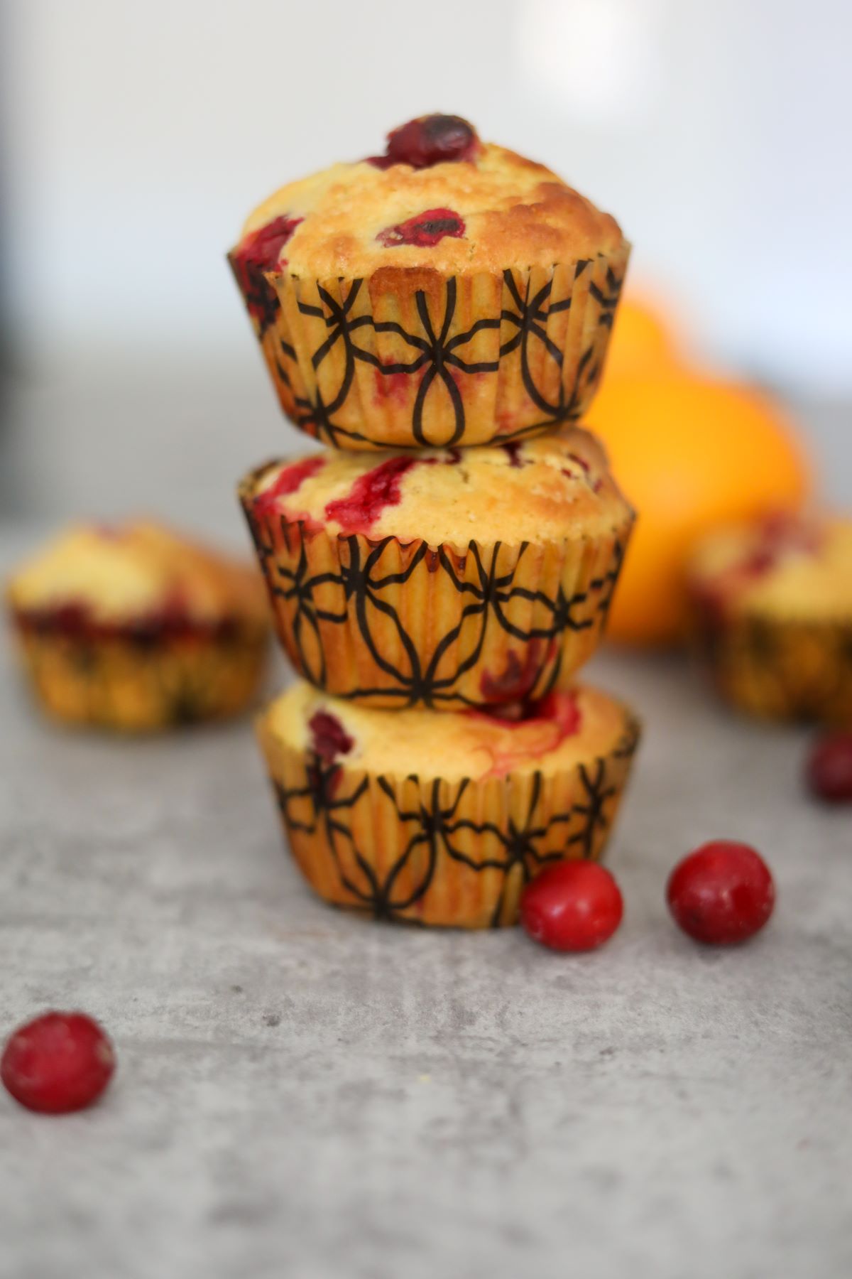 close up of a stack of cranberry orange muffins