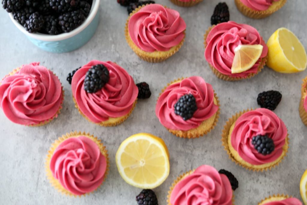 lemon cupcakes with bowl of blackberries