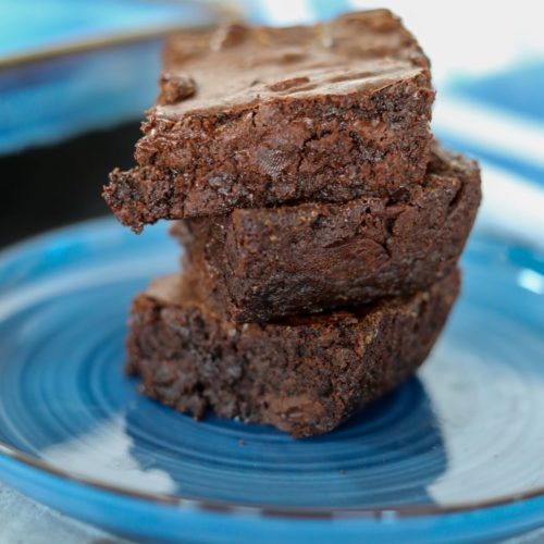 stack of three brownies on a blue plate