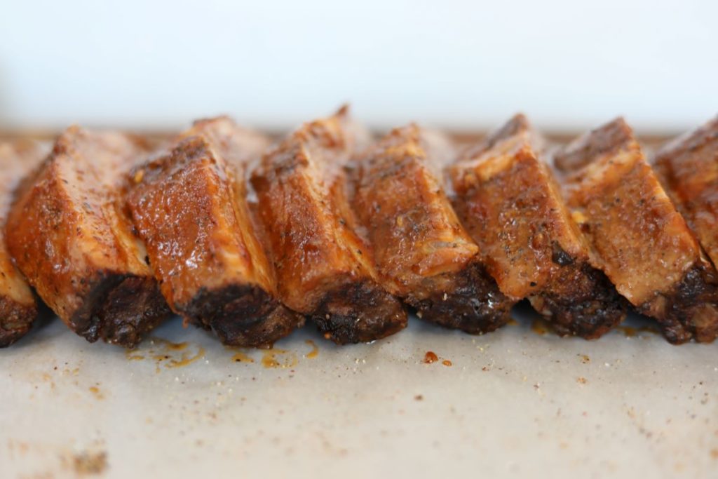 close up of watermelon barbeque ribs on parchment paper