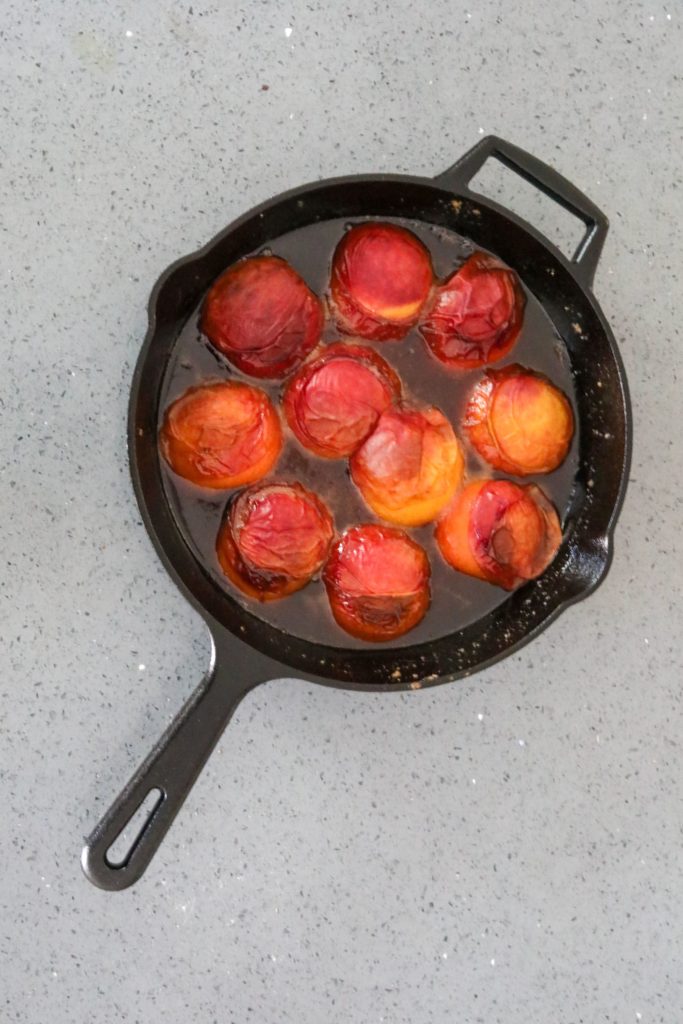 baked peaches in a cast iron skillet