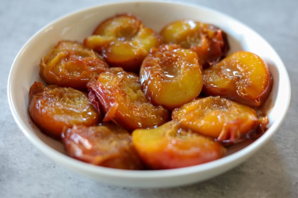 A bowl of bourbon baked peaches