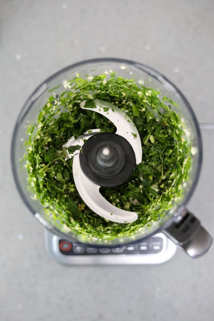 Food processor with chopped chimichurri ingredients