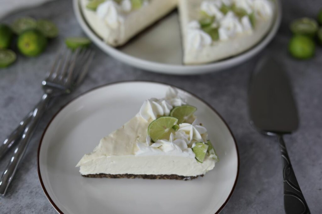 A slice of key lime cheesecake on a white plate