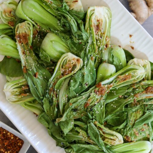 Roasted bok choy on a white platter