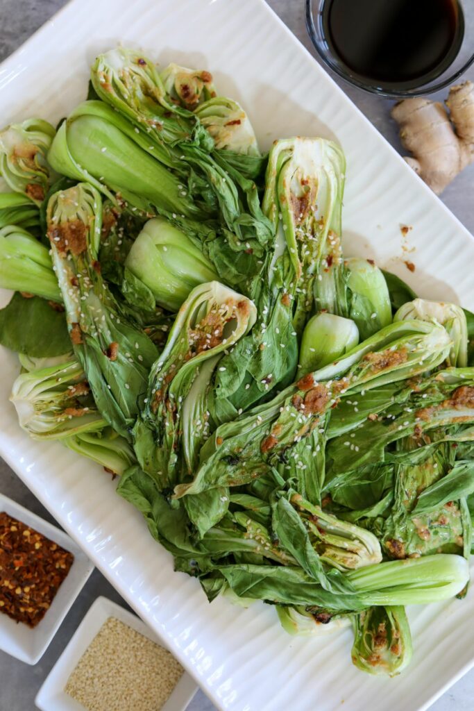 Roasted bok choy on a white platter