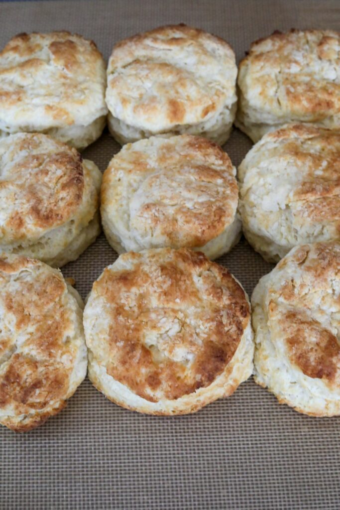 Cooked biscuits on a lined baking sheet
