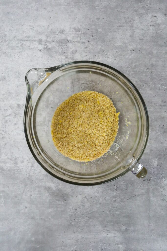 Rubbed sugar and lemon zest in a mixing bowl