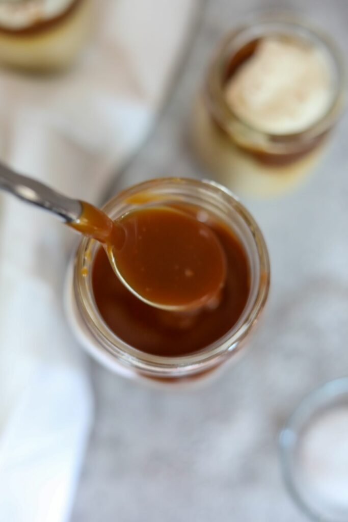 bourbon caramel sauce on a spoon over a jar
