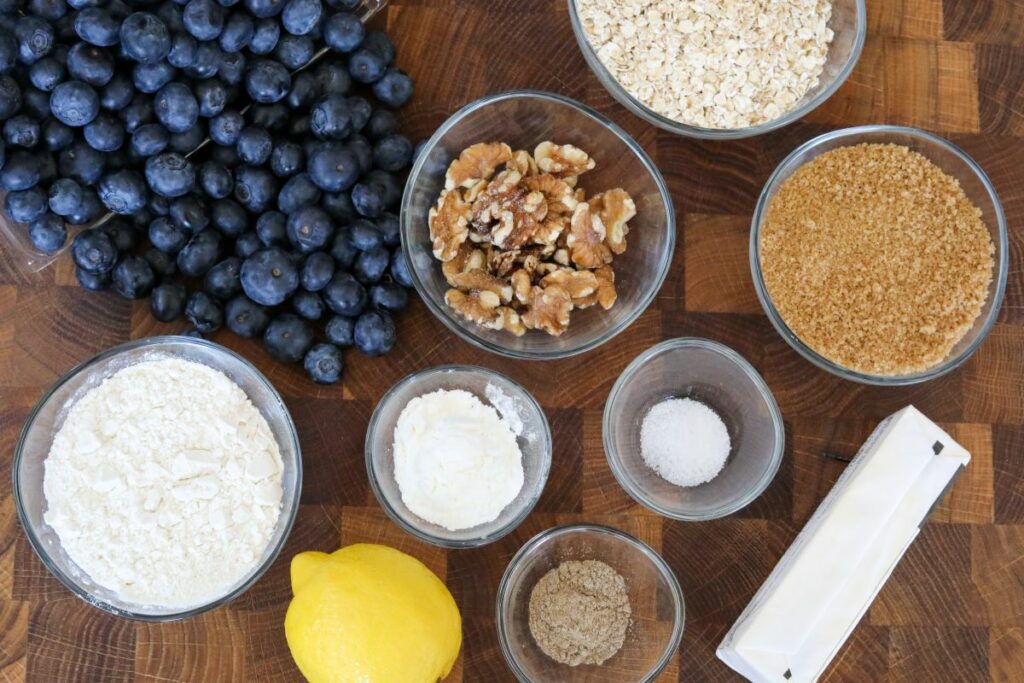 Ingredients for blueberry crisp on a wooden cutting board