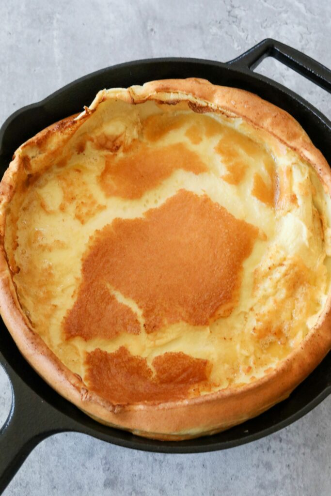 Cooked Dutch baby in an iron skillet