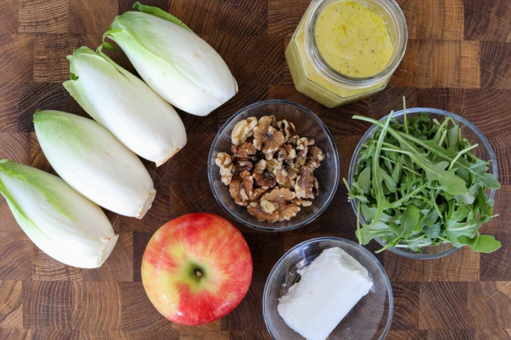Ingredients for endive salad on a cutting board