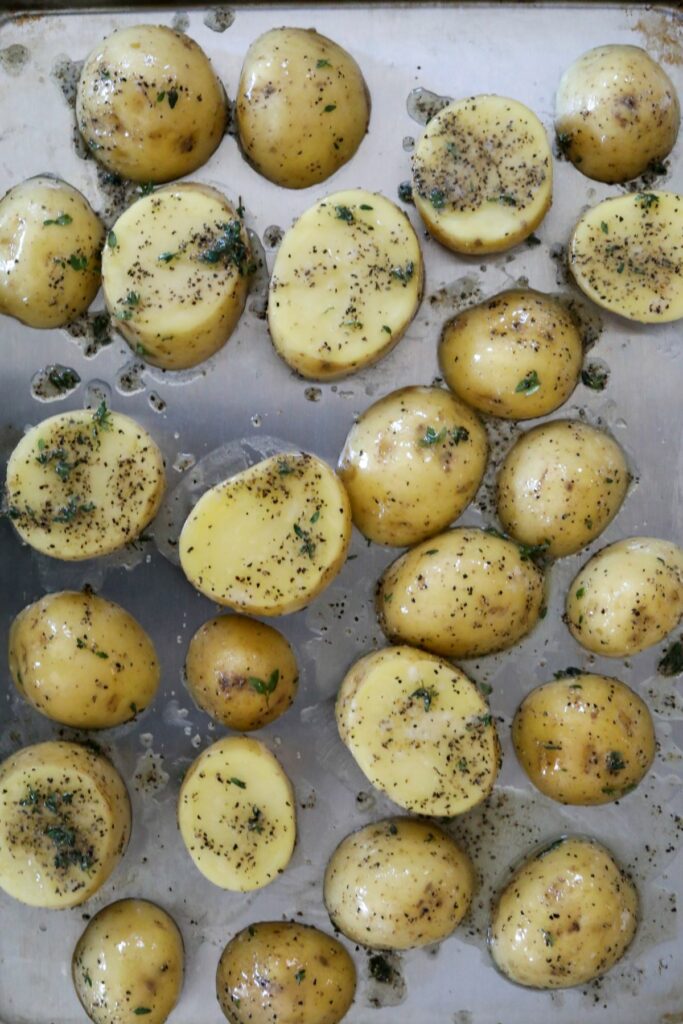 Uncooked potatoes on a sheet pan