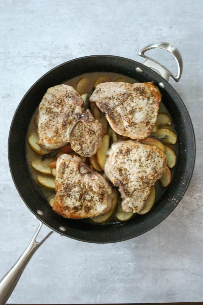 Cooked sage pork chops in a pan