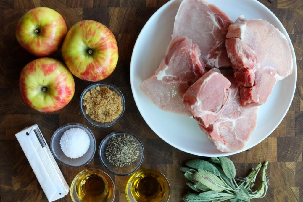 Ingredients for sage pork chops on a wooden cutting board