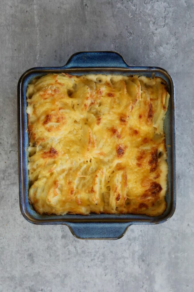 baked scalloped potatoes in a blue baking dish