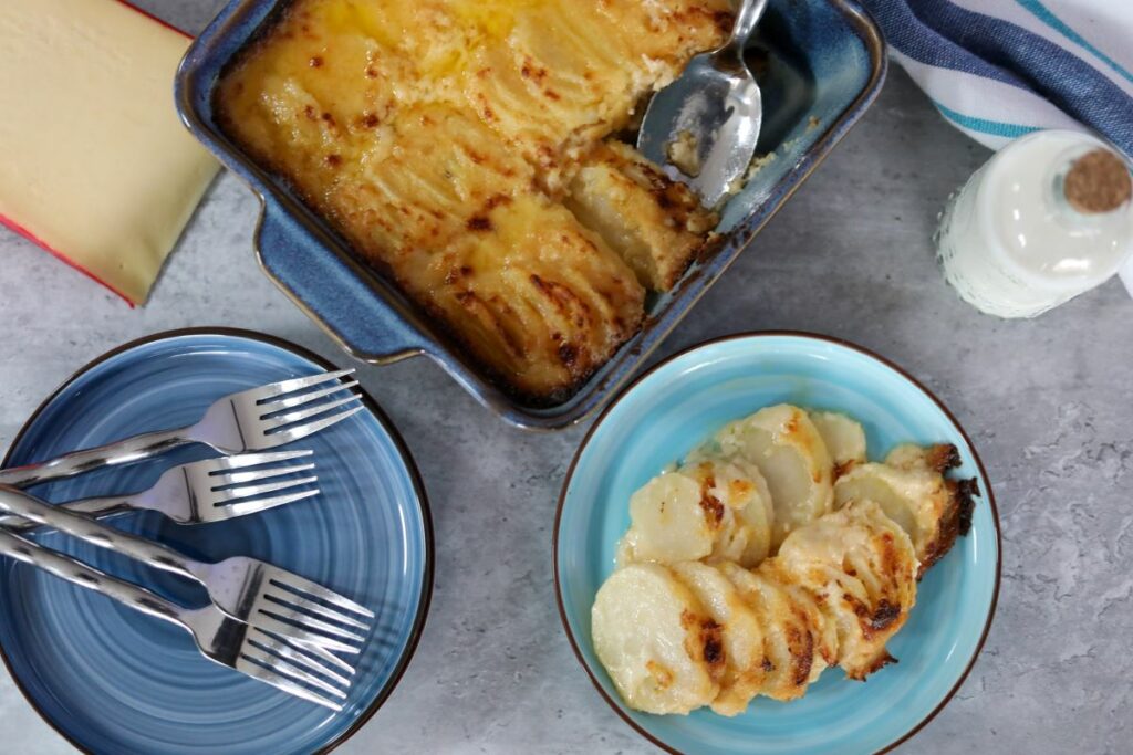 A serving of scalloped potatoes on a blue bowl