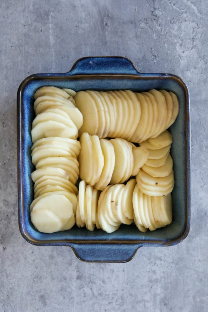 Slices of potatoes in a square baking dish