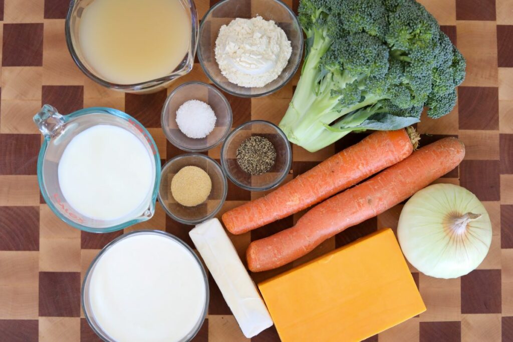 Ingredients for broccoli and cheddar soup on a cutting board