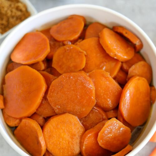 candied sweet potatoes in a white bowl