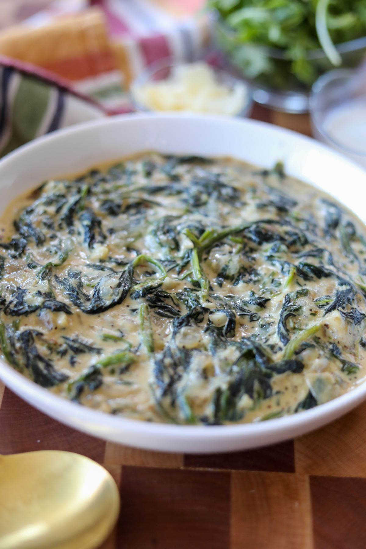 Close up of a white bowl of creamed spinach
