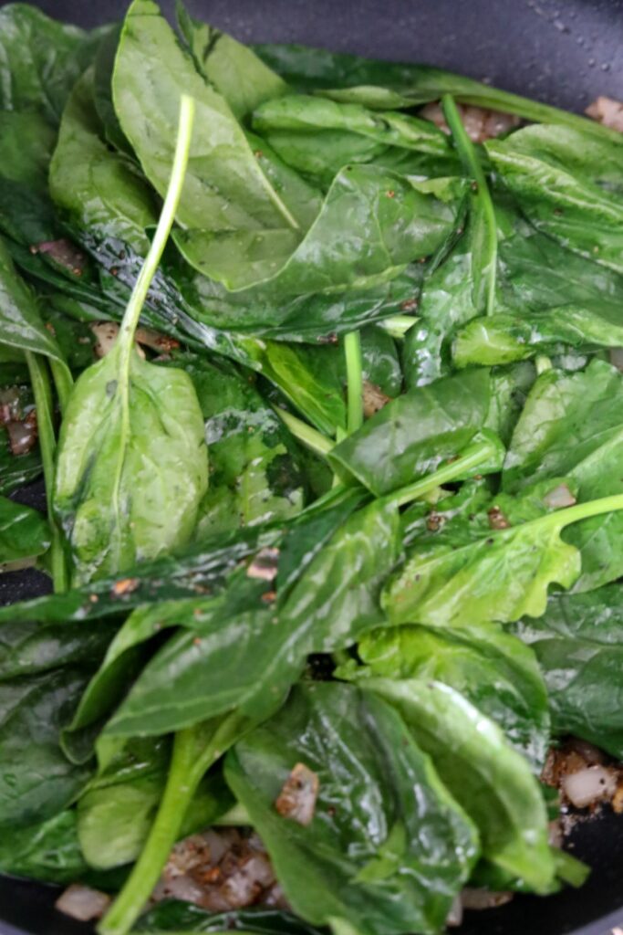 wilting spinach in a pan