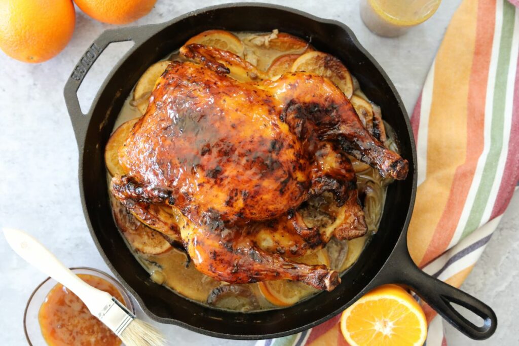 orange glazed chicken cooling in a skillet