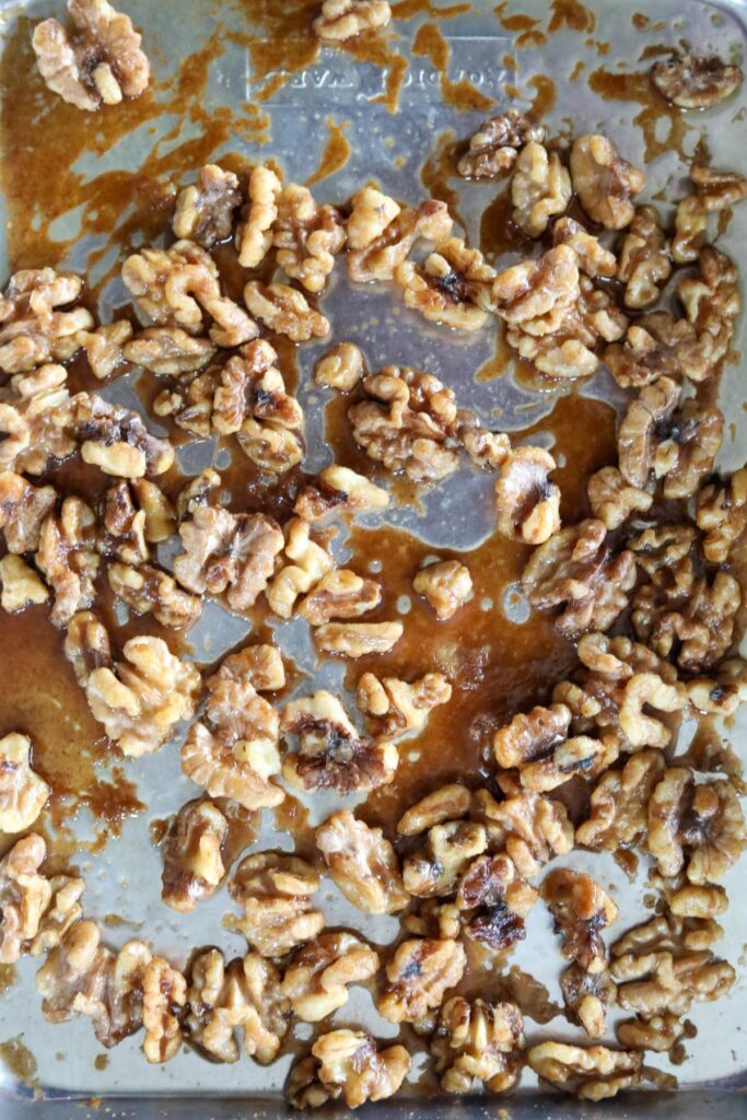 Toasted candied walnuts on a sheet pan