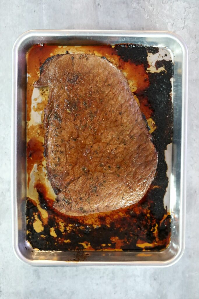 Cooked steak on a sheet pan