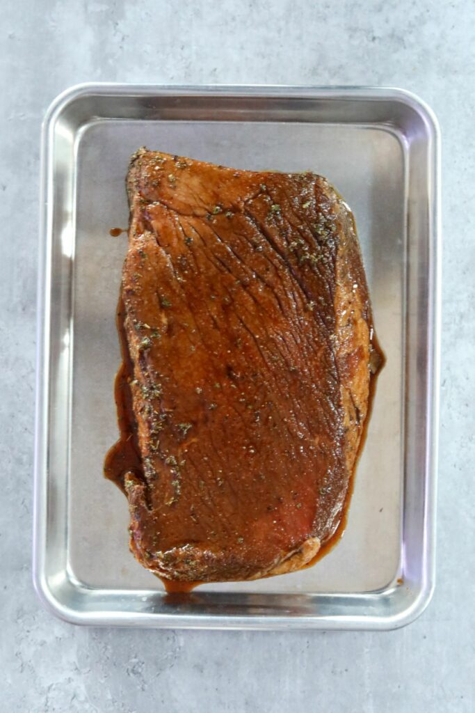 uncooked steak on a sheet pan