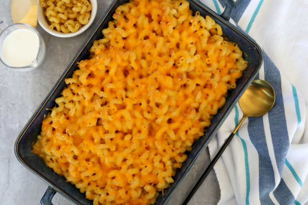 A blue baking dish with macaroni and cheese
