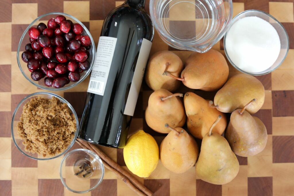 Ingredients for poached pears on a cutting board