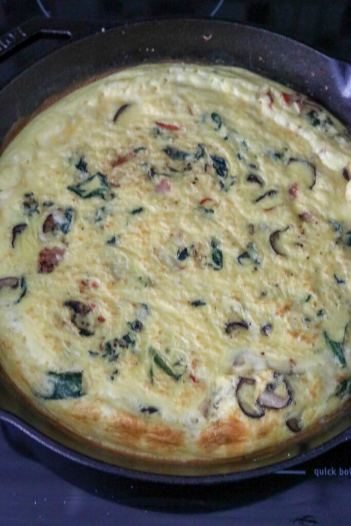 Baked spinach and mushroom frittata in a cast iron skillet