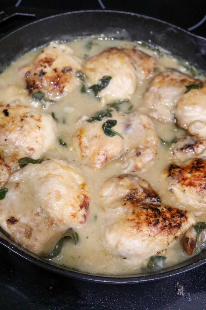 Chicken added back to the wine sauce in a skillet