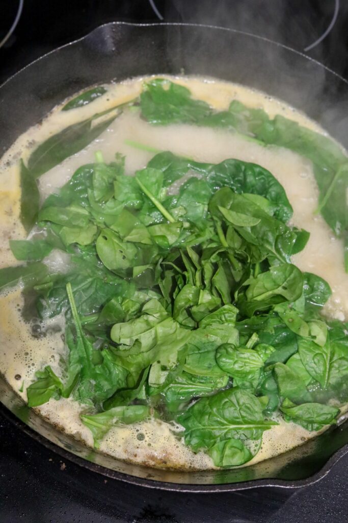 Spinach added to the wine sauce