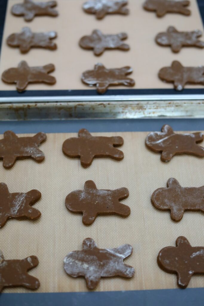 Unbaked gingerbread cookies on a baking sheet