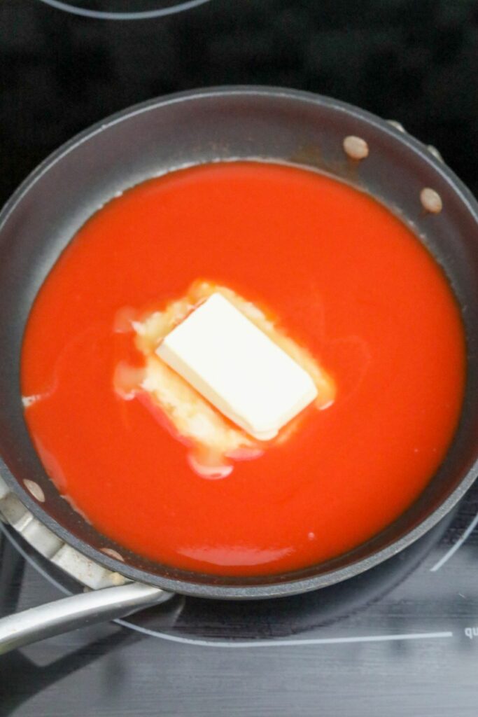 Buffalo sauce and butter in a pan