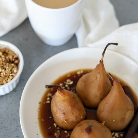 bourbon poached pears in a white bowl