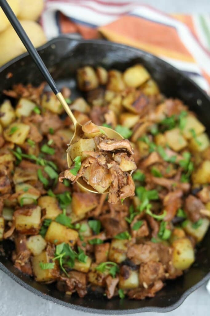 A spoonful of chanterelle mushrooms and herbed potatoes