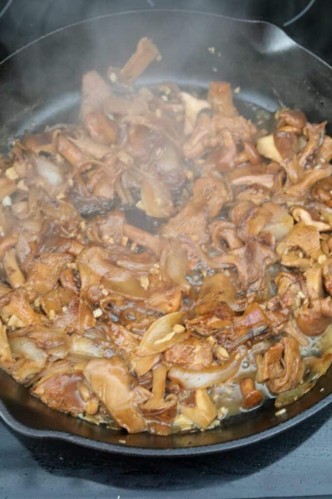 Reduced white wine and mushrooms in a skillet