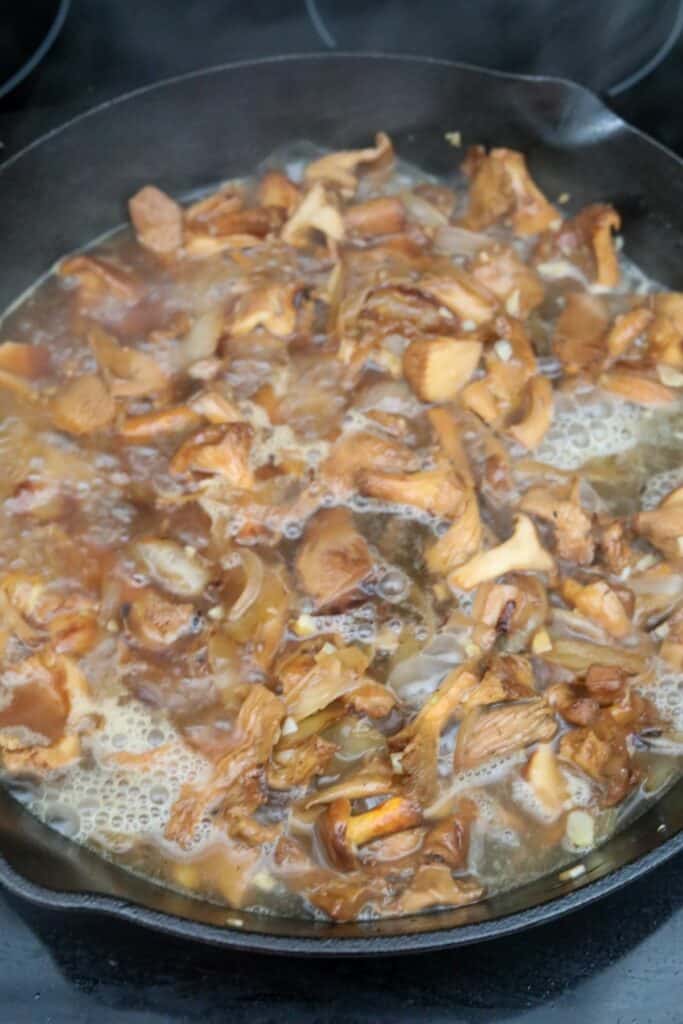 White wine added to chanterelle mushrooms and onions