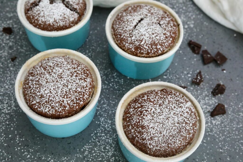 4 chocolate souffles covered in powdered sugar