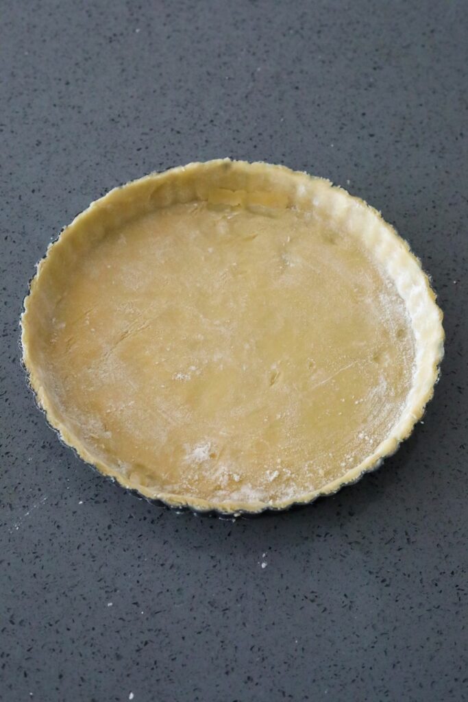 Uncooked pate sucree in a tart pan