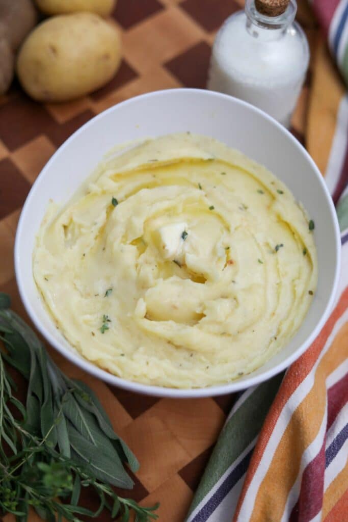 A white bowl with mashed potatoes