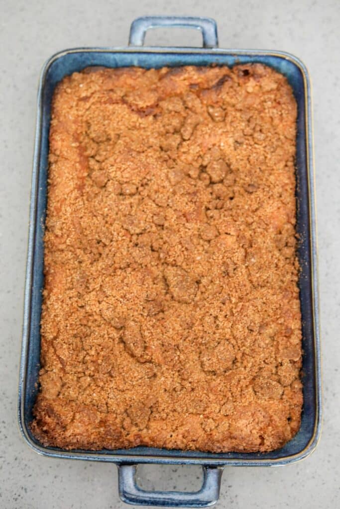Baked apple coffee cake in a blue baking dish