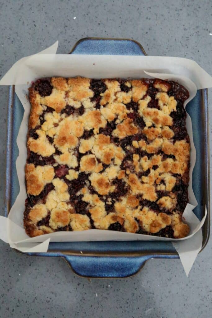 Baked blackberry crumb bars in a baking dish